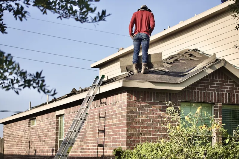 Professional roofer working on a residential roof in Argentine